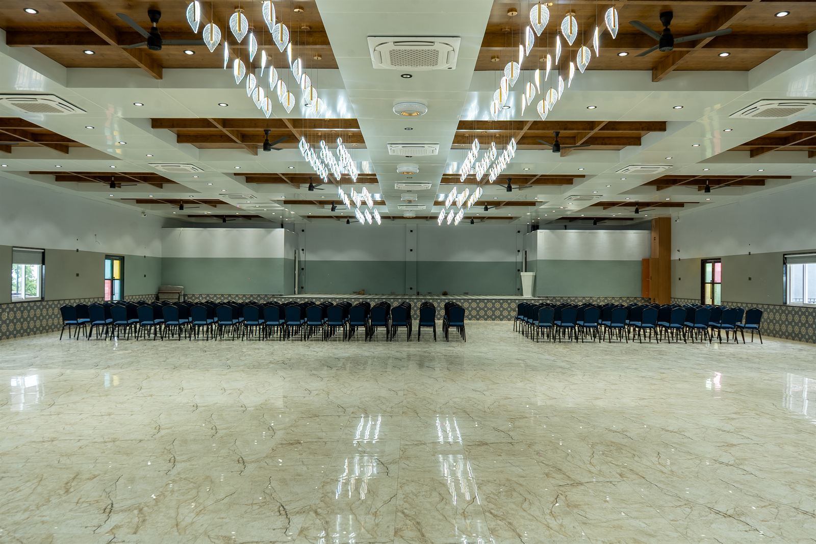 Banquet hall with chandeliers and chair rows